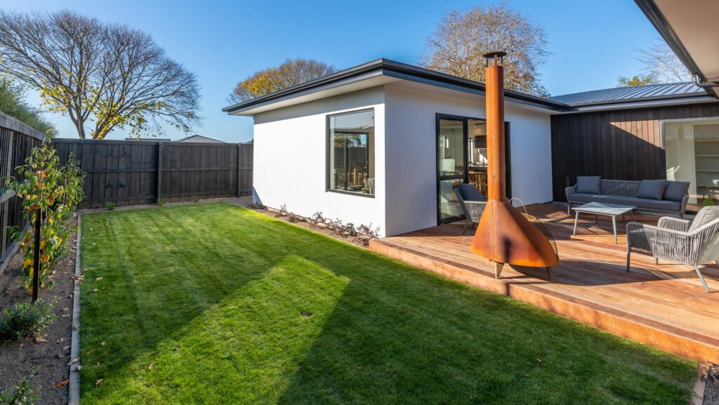 Outdoor living area of a modern new build home, highlighting landscaped grounds and deck space, suited for buyers searching for new build homes, homes for sale, land for sale, house and land packages, or architectural homes.