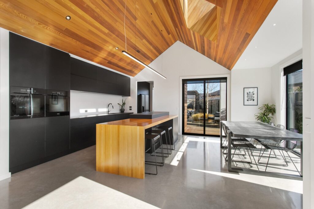 Modern kitchen and dining area with high timber ceilings, showcasing modern house design in a new build house ideal for homes for sale and architectural property.