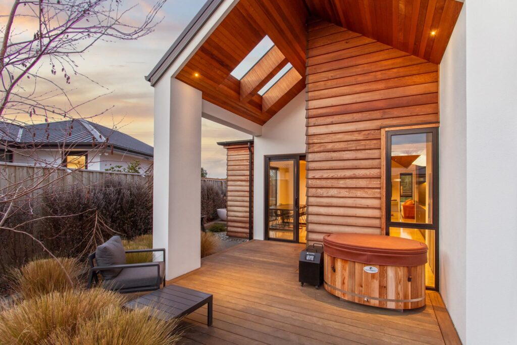Covered outdoor deck of a modern house featuring timber detailing and skylights, showcasing architectural homes and luxury property for sale with seamless indoor outdoor living.