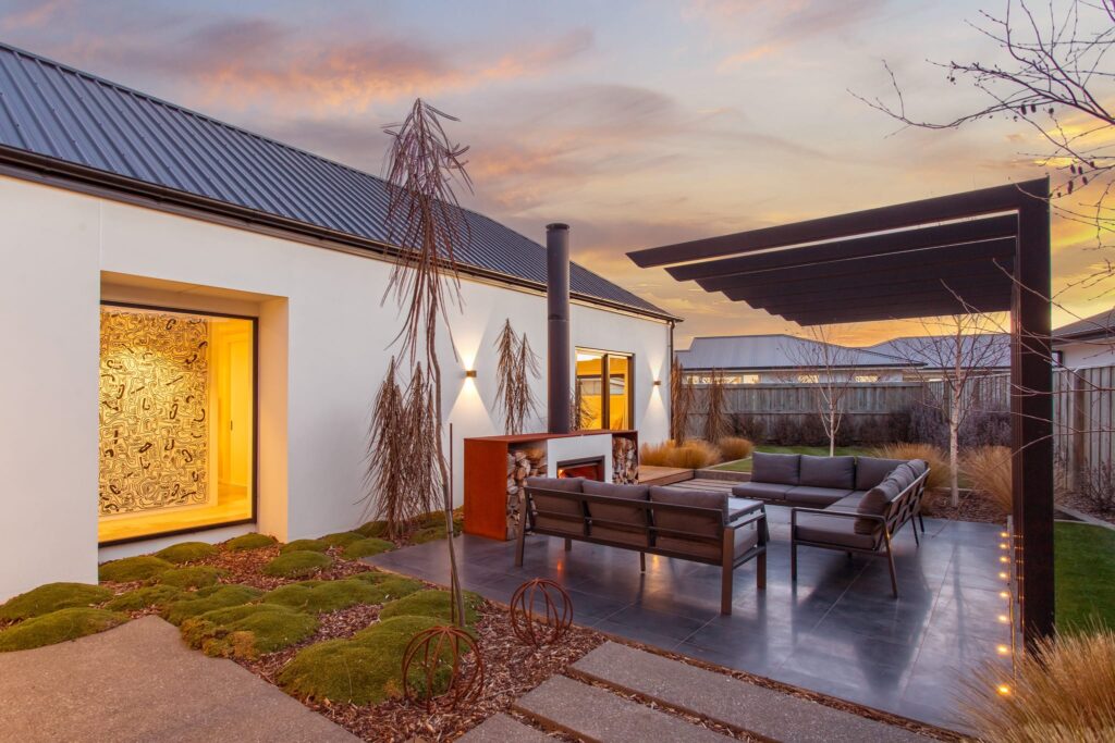 Outdoor entertaining space with pergola and fireplace, showcasing luxury homes for sale and architectural homes designed for modern living.