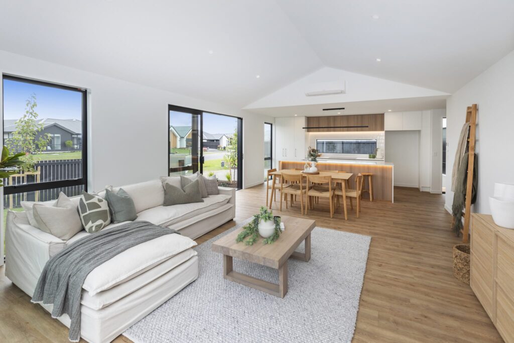 Open plan living and dining area in a modern home featuring contemporary interiors and new build homes for sale.