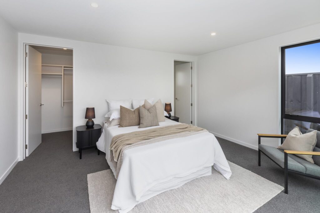 Master bedroom in a modern new build home highlighting clean design and comfortable living spaces.