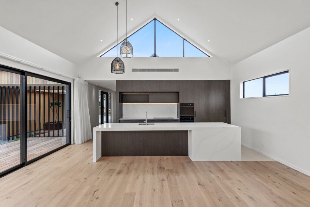 Open plan kitchen and living space in a modern new build home designed for luxury homes and family living.
