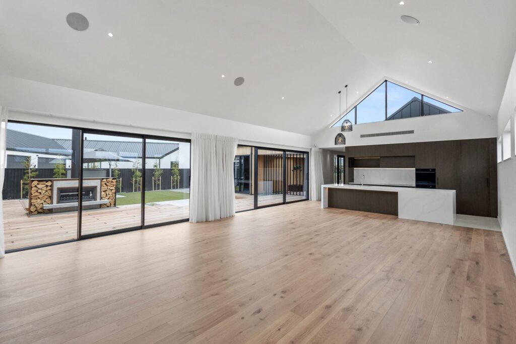 Spacious open plan interior of a modern home showcasing new houses for sale with premium finishes.