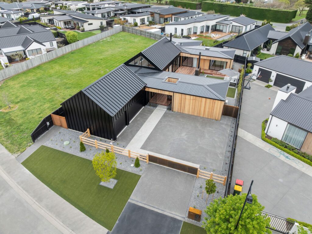 Aerial view of modern houses for sale within a planned house and land package development featuring new build homes.