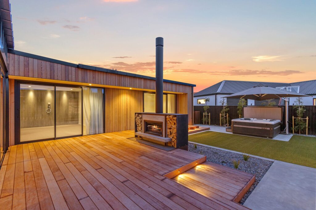 Luxury new build homes with outdoor fireplace and entertaining area, highlighting modern house design, architectural homes and high quality property for sale within sought after new homes developments.