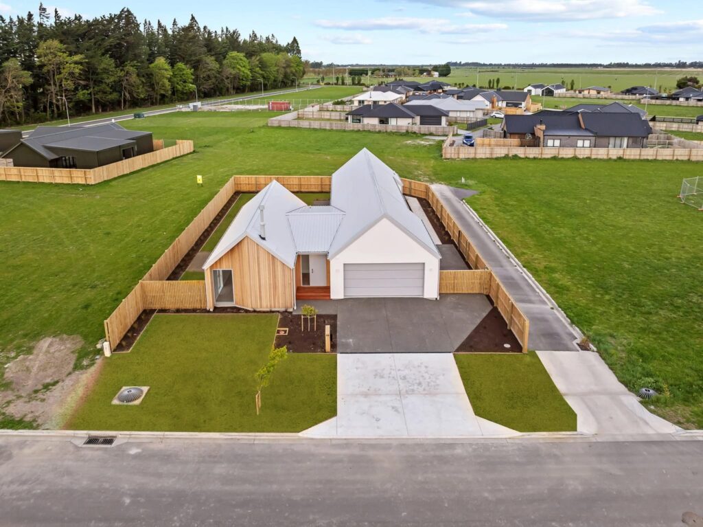 Elevated street view of a modern architectural home and land for sale, appealing to buyers looking for new homes for sale, houses to buy, affordable homes, luxury homes, and new build houses.