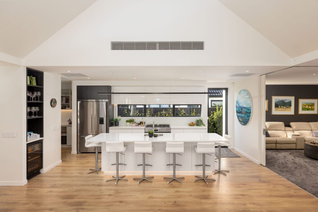 Open plan kitchen and living space in a modern home, showcasing new build houses for sale with high end finishes, ideal for families seeking homes for sale and quality new build homes.