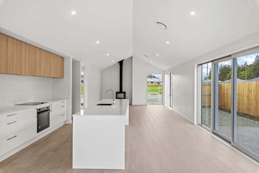 Open-plan kitchen and dining area in a modern house, featuring clean architectural lines suited for buyers exploring new build homes, affordable homes, luxury homes, and modern houses for sale.